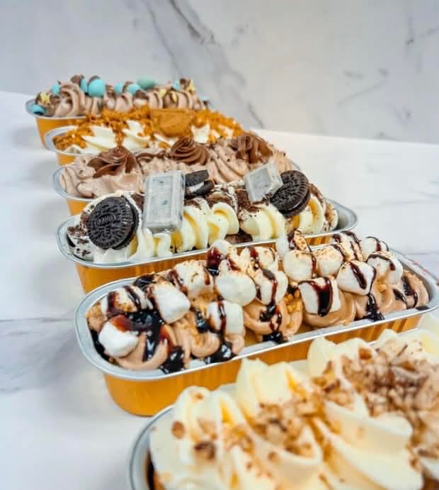 Six gourmet dessert boats with Oreo, s'mores, chocolate, and caramel toppings
