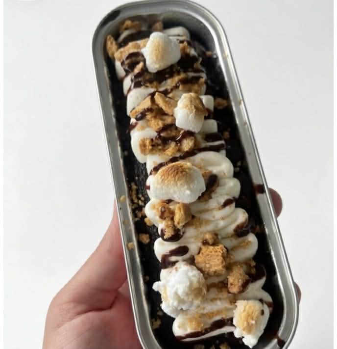 S'mores mini dessert boat with toasted marshmallows and chocolate drizzle